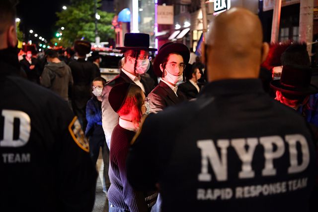 Members of the Orthodox Jewish community gather during a protest over new coronavirus restrictions.
